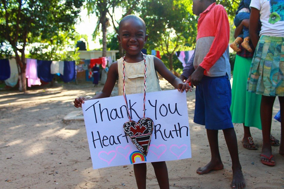 Young girl with sign thanking Heart of Ruth